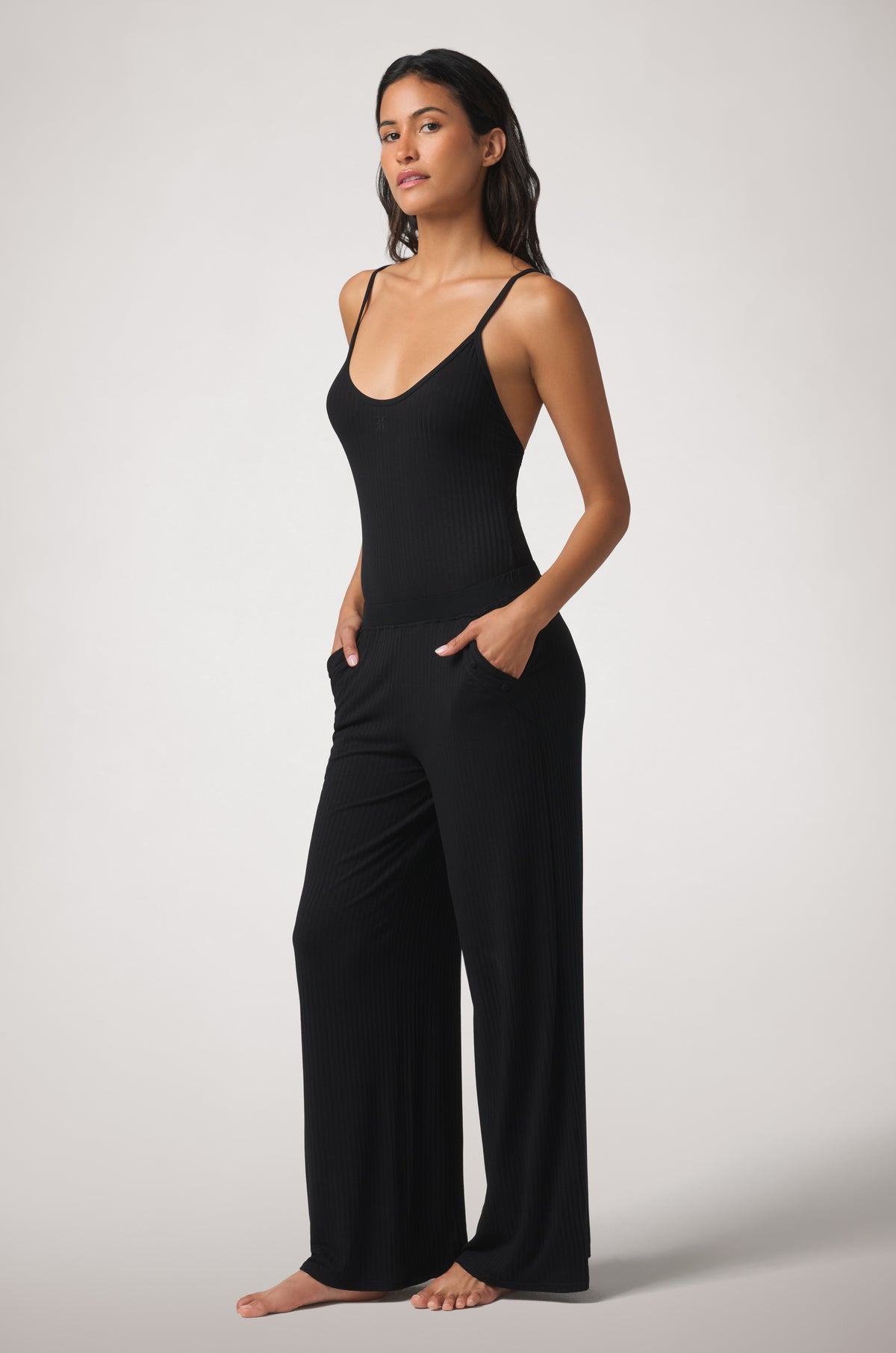 Kiki de Montparnasse Le Boy Bodysuit in black stretch rib knit with track pant side