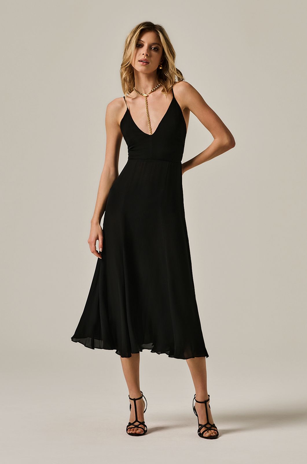 calf length flowy dress with deep plunge line at chest. double layered dress and exposed back. front view