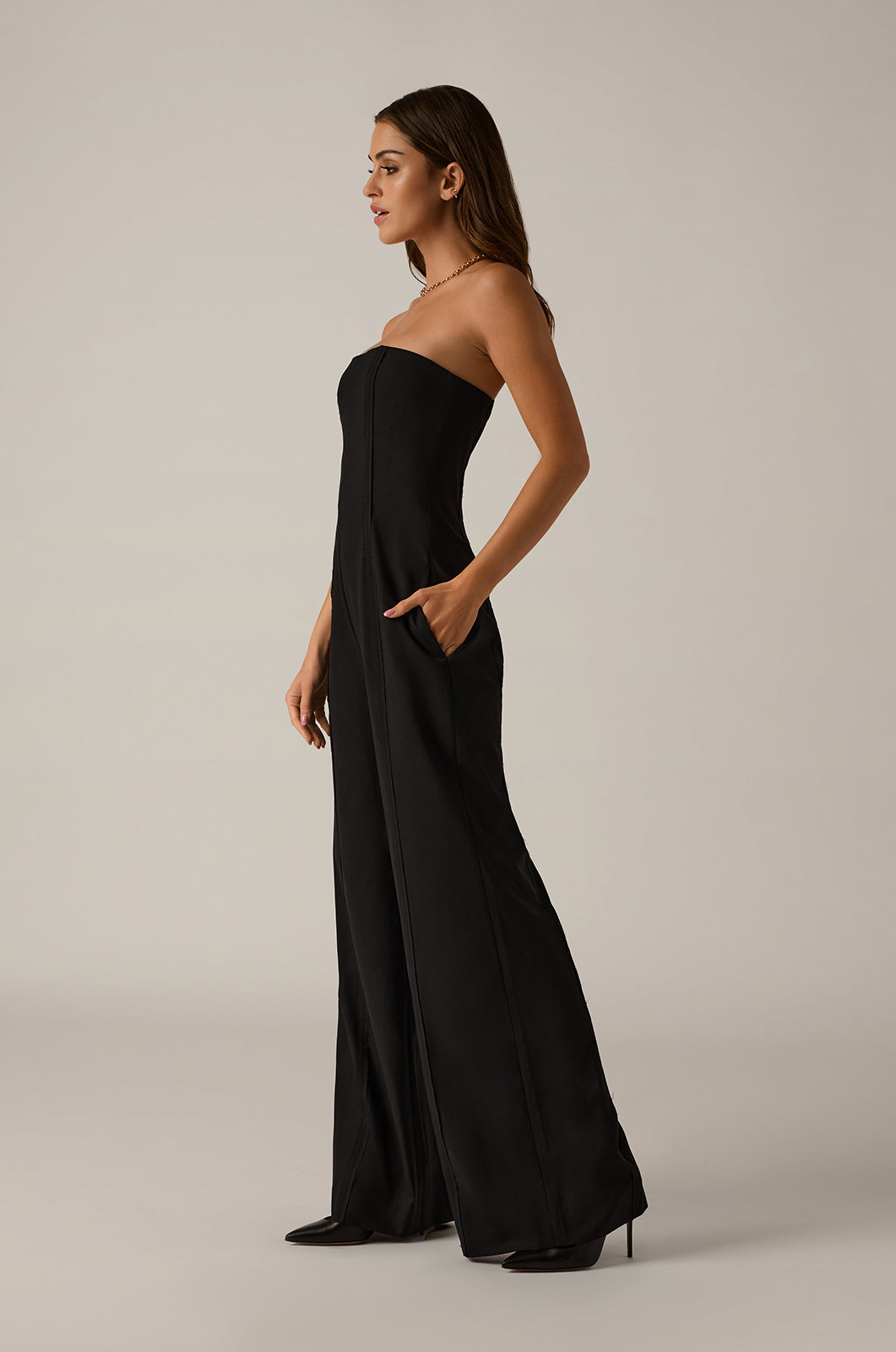 Exposed seam strapless jumpsuit straight wide leg side view