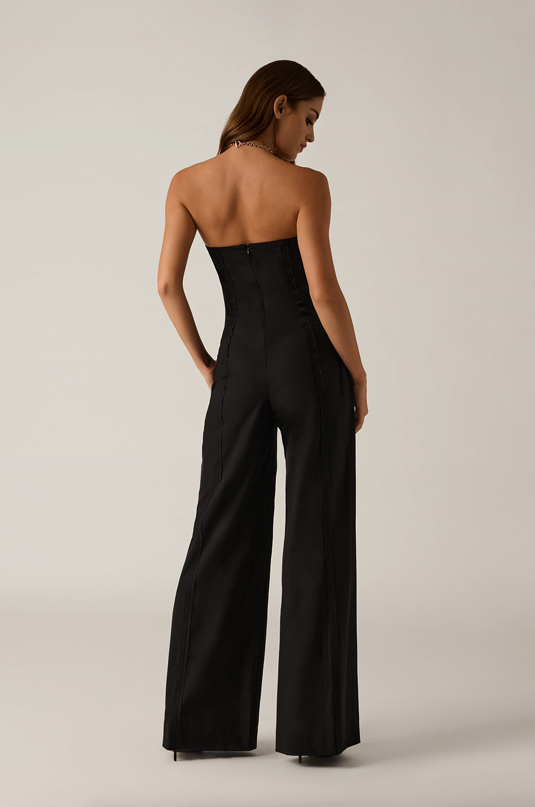 Exposed seam strapless jumpsuit straight wide leg back view