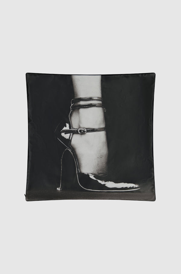 Black sham with photograph of a womans foot wearing a black stiletto
