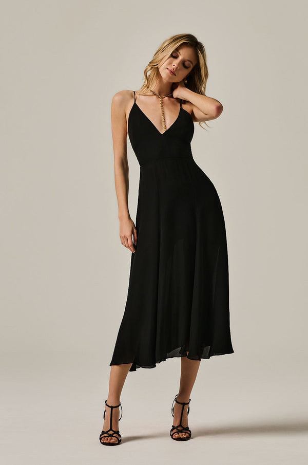 calf length flowy dress with deep plunge line at chest. double layered dress and exposed back