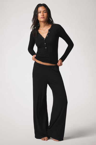 Kiki de Montparnasse Le Boy Henley top in black stretch rib knit with Track pant, front.