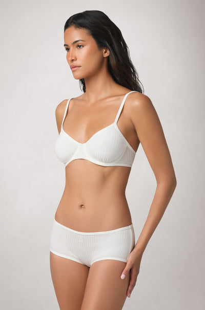 Sleek, low-profile shape with softly curved cups that sit close to the body and slim straps extending over the shoulders.