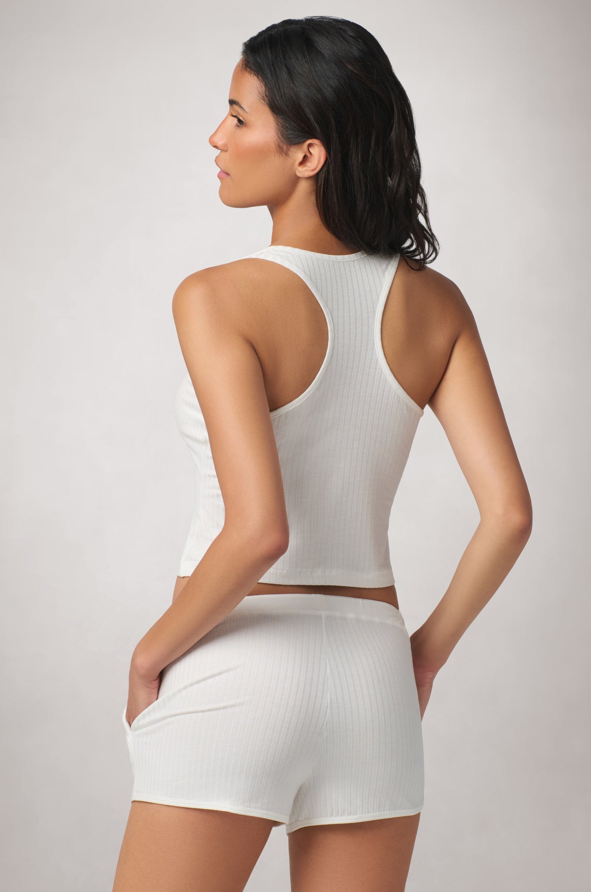 Clean racerback design with straps that angle inward toward the upper back, creating a sporty, streamlined finish.