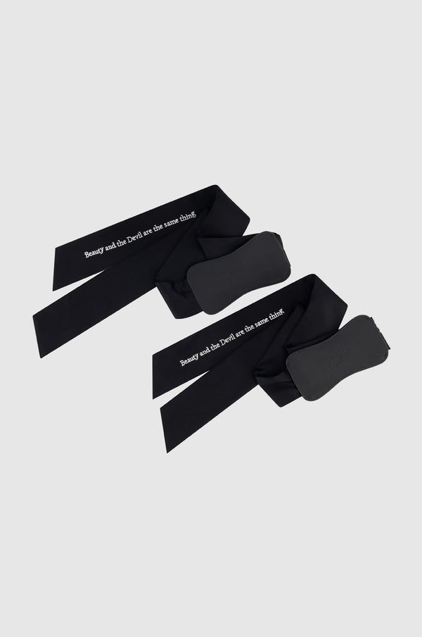 Black My Ties, embellished with black rivets and embroidered with "Beauty and the devil are the same thing," attributed to Robert Mapplethorpe.