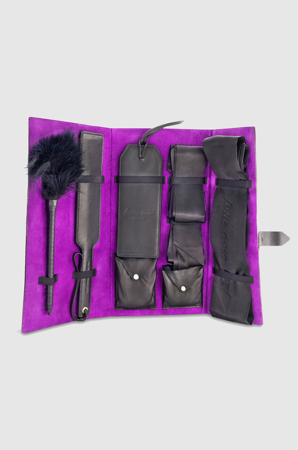 Kit with inkjet print of Tulip, 1985, by Robert Mapplethorpe on the exterior and purple interior including: 1 x Blindfold 1 x My Ties (sold as a pair) 1 x Paddle 1 x Door Tag 1 x Tickler 1 x Bullet 1 x Handcuff Wristlets
