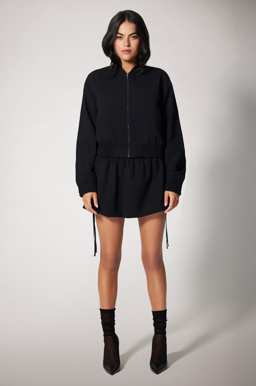Black Cropped Cinched End Mock Neck Gold Zip Up Suiting Bomber Jacket Front