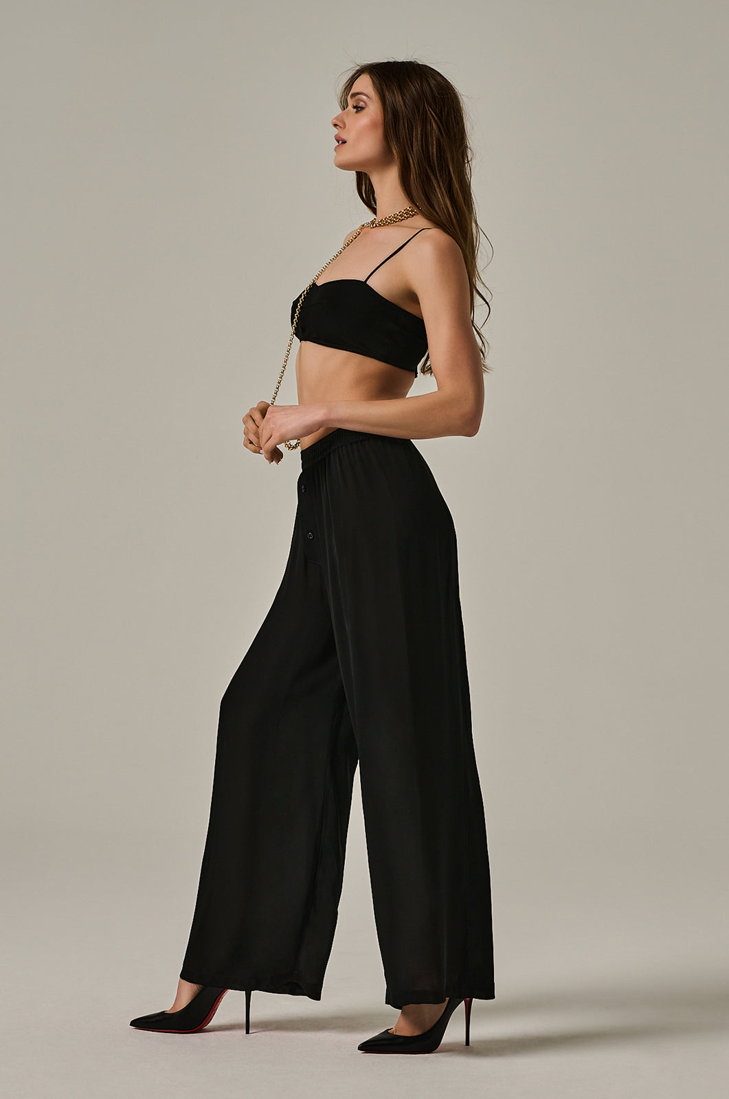 Long black Georgette silk boxer pant with black button closure in front. Elastic waistband and wide legged