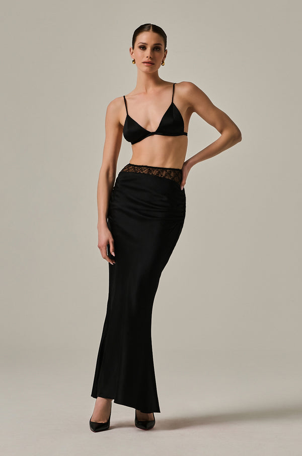 Solid black long silk skirt with handcuff embroidered panel. Ruffled sides on hip.