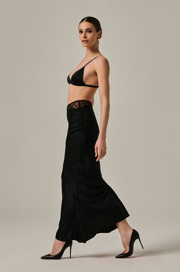 Solid black long silk skirt with handcuff embroidered panel. Ruffled sides on hip.  Edit alt text