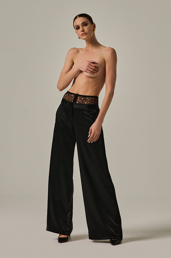 Solid black long silk pant with French stretch silk panel at top. Hook-and-eye closure at front. Side pockets.