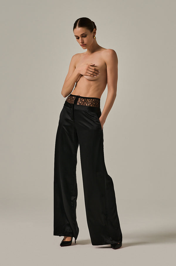 Solid black long silk pant with French stretch silk panel at top. Hook-and-eye closure at front. Side pockets.