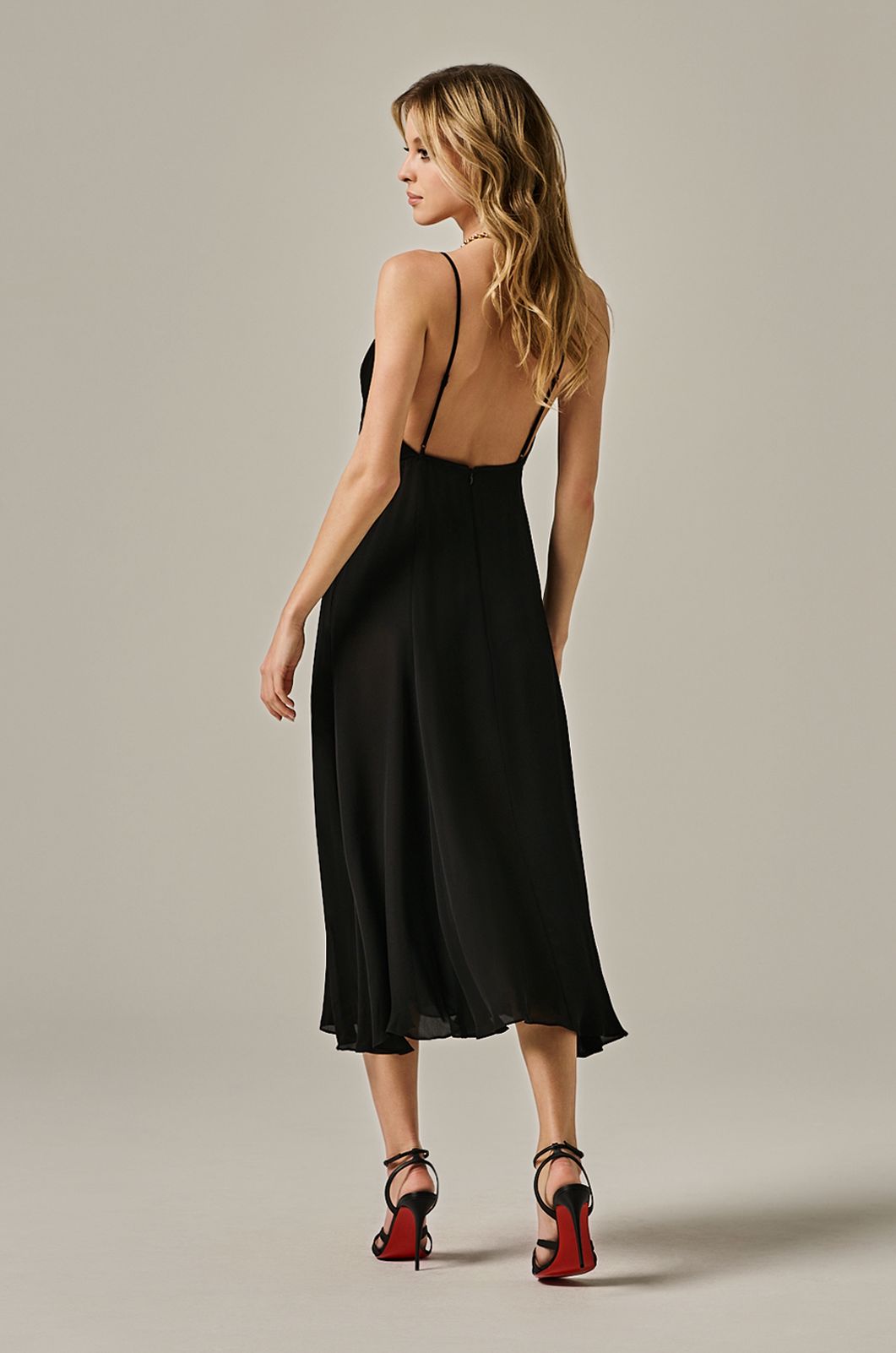 calf length flowy dress with deep plunge line at chest. double layered dress and exposed back