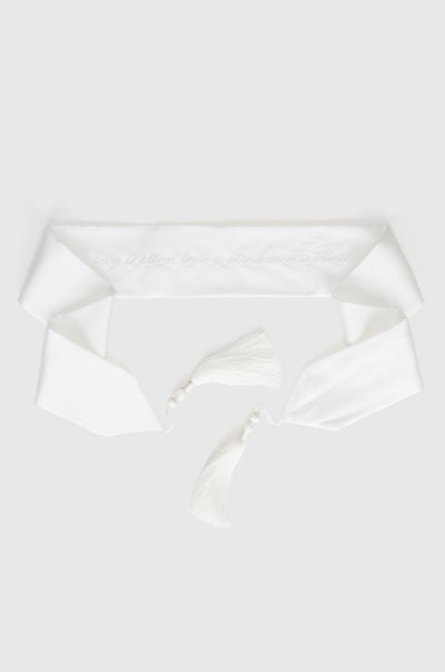 Ivory silk blindfold with white writing finished with tassels at each end
